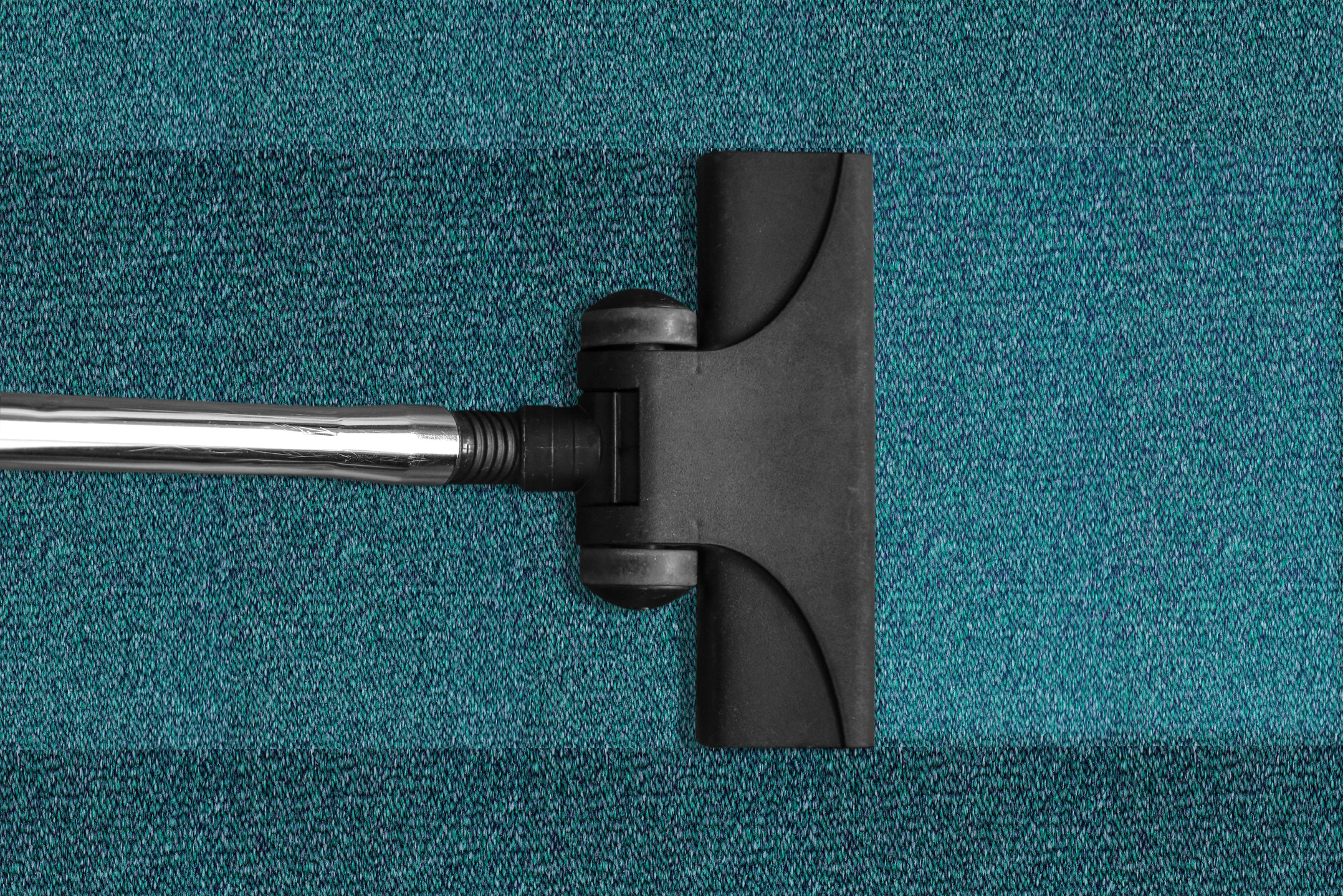 Top View of a Vacuum Cleaner Cleaning a Carpet